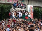 Protesters climb a public monument as they celebrate after getting the news of Prime Minister Sheikh Hasina's resignation, in Dhaka, Bangladesh, Monday, Aug. 5, 2024. Protesters climb a public monument as they celebrate after getting the news of Prime Minister Sheikh Hasina's resignation, in Dhaka, Bangladesh, Monday, Aug. 5, 2024.
