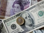 (FILES) This file photo taken on April 22, 2022 shows pounds and US dollar banknotes displayed on a table in London. -(AFP) (FILES) This file photo taken on April 22, 2022 shows pounds and US dollar banknotes displayed on a table in London. -(AFP)