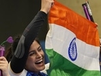 India's Manu Bhaker celebrates after winning bronze in the 10m air pistol women's final(AP)