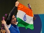 India's Manu Bhaker celebrates with the Indian flag after winning the bronze medal in the 10m air pistol women's final.