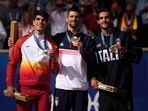Serbia's Novak Djokovic , center, gold medalist, Spain's Carlos Alcaraz, left, silver medalist, and Italian bronze medalist Lorenzo Musetti pose on the podium, Serbia's Novak Djokovic , center, gold medalist, Spain's Carlos Alcaraz, left, silver medalist, and Italian bronze medalist Lorenzo Musetti pose on the podium,
