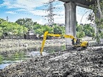 MCD officials clear the Barapullah drain near Nizamuddin on Sunday