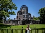 A man takes pictures in front of Hiroshima Prefectural Industrial Promotion Hall, commonly known as the atomic bomb dome in Hiroshima. August 6, 2024, observed solemnly as Hiroshima Day around the world, will be the 79th anniversary of the atomic bombing of the Japanese city in the final year of World War II as on this day in 1945, the United States dropped the very first deployed nuclear bomb in the city of Hiroshima, wiping out an estimated 39 percent of the population, most of who were civilians. Today, Hiroshima Prefectural stands as a poignant symbol of peace and resilience and visiting Hiroshima Prefectural on Hiroshima Day is not just a journey through history; it is an immersive experience that blends solemn remembrance with a powerful message of hope for future generations. Trips and tours to Hiroshima Prefectural provide a deeper understanding of Hiroshima's transformation from a site of tragedy to a beacon of peace - (Photo by Philip FONG / AFP)