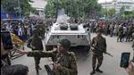 Bangladeshi security officers keep vigil on a street in Dhaka on Monday. (AP) Bangladeshi security officers keep vigil on a street in Dhaka on Monday. (AP)