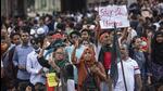 People shout slogans as they take part in a protest rally in Dhaka on Monday. (AP Photo) People shout slogans as they take part in a protest rally in Dhaka on Monday. (AP Photo)