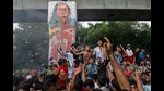 Protesters celebrate beside a defaced portrait of Prime Minister Sheikh Hasina after news of her resignation, in Dhaka, Bangladesh. (AP) Protesters celebrate beside a defaced portrait of Prime Minister Sheikh Hasina after news of her resignation, in Dhaka, Bangladesh. (AP)