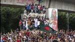 Protesters climb a public monument as they celebrate the news of Prime Minister Sheikh Hasina's resignation, in Dhaka, Bangladesh, on Monday. (AP) Protesters climb a public monument as they celebrate the news of Prime Minister Sheikh Hasina's resignation, in Dhaka, Bangladesh, on Monday. (AP)