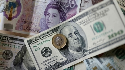 (FILES) This file photo taken on April 22, 2022 shows pounds and US dollar banknotes displayed on a table in London. - (AFP) (FILES) This file photo taken on April 22, 2022 shows pounds and US dollar banknotes displayed on a table in London. - (AFP)