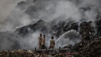 Firefighters fight a blaze at the Ghazipur landfill in Delhi on April 22. (Reuters)