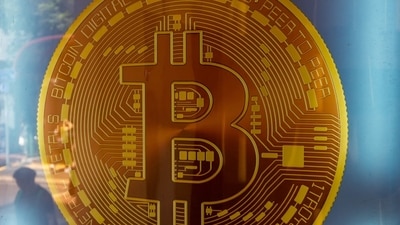 Signage for Bitcoin cryptocurrency is seen. Cryptocurrencies reeled from a bout of risk aversion in global markets and at one point sending Bitcoin down more than 11%. (Bloomberg) Signage for Bitcoin cryptocurrency is seen. Cryptocurrencies reeled from a bout of risk aversion in global markets and at one point sending Bitcoin down more than 11%. (Bloomberg)