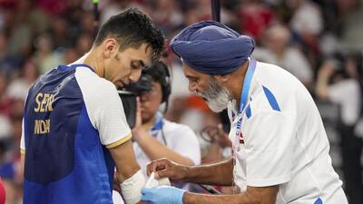 India's Lakshya Sen being given medical assistance during his men's singles bronze medal badminton match against Malaysia's Lee Zii Jia at the 2024 Summer Olympics, in Paris, on Monday. (PTI) India's Lakshya Sen being given medical assistance during his men's singles bronze medal badminton match against Malaysia's Lee Zii Jia at the 2024 Summer Olympics, in Paris, on Monday. (PTI)