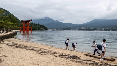 High school students gather in front of the torii of Itsukushima Shrine (back), the popular tourist destination of Miyajima island in Hiroshima Prefecture. (Photo by Philip FONG / AFP) High school students gather in front of the torii of Itsukushima Shrine (back), the popular tourist destination of Miyajima island in Hiroshima Prefecture. (Photo by Philip FONG / AFP)