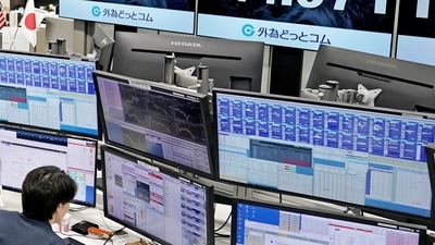 An employee of the foreign exchange trading company Gaitame.com works in front of monitors displaying the Japanese yen exchange rate against the US dollar. (Reuters)