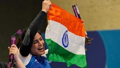 India's Manu Bhaker celebrates with the Indian flag after winning the bronze medal in the 10m air pistol women's final. (AP) India's Manu Bhaker celebrates with the Indian flag after winning the bronze medal in the 10m air pistol women's final. (AP)