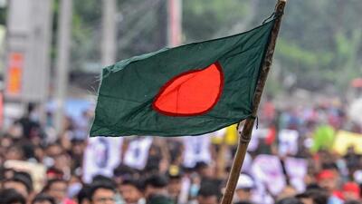 Protesters wave the Bangladesh national flag during a march in Dhaka amid the ongoing civil unrest. (AFP Photo) Protesters wave the Bangladesh national flag during a march in Dhaka amid the ongoing civil unrest. (AFP Photo)