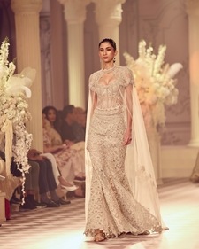 A model wearing a corset blouse paired with a cape at Roseroom by Isha Jajodia's collection showcase at India Couture Week 2024 (Photo: Instagram)