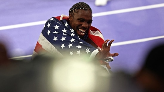 US' Noah Lyles celebrates after winning the men's 100m final of the athletics event at the Paris 2024 Olympic Games at Stade de France in Saint-Denis, north of Paris, on August 4, 2024. (AFP / Anne-Christine POUJOULAT)