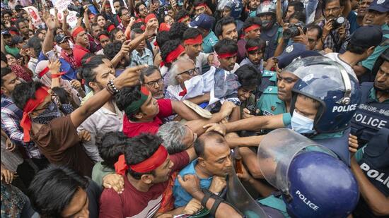 Activists clash with the police during a march to remember victims of recent countrywide clashes in Dhaka, Bangladesh on Monday. (AP)