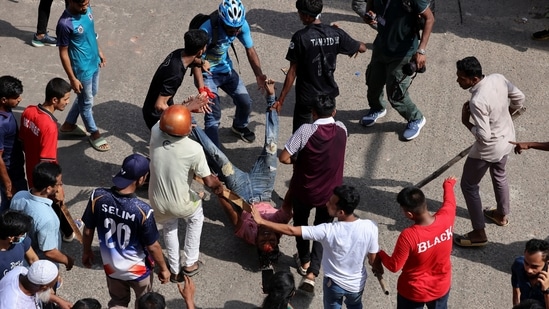 A man, who got injured during a clash between police, pro-government supporters and protesters, is taken in a safe place by fellow demonstrators, after anti-quota protesters were demanding the stepping down of the Bangladeshi Prime Minister Sheikh Hasina at the Bangla Motor area, in Dhaka(REUTERS)