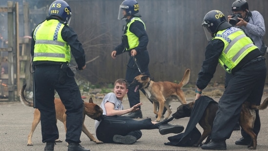 Police dogs attack a man during an anti-immigration protest in Rotherham, Britain. (REUTERS)