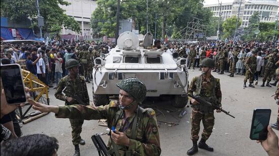 Bangladeshi security officers keep vigil on a street in Dhaka on Monday. (AP)