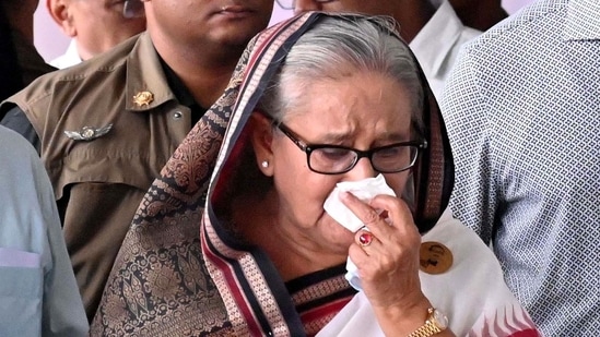 Sheikh Hasina (C) weeps while she visits a metro station in Mirpur vandalized by students during the anti-quota protests. (AFP file photo)