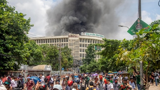 Black smoke rises from the Bangabandhu Sheikh Mujib Medical University (BSMMU) during clashes between protesters and Awami League members, on the first day of the non-cooperation movement at Dhaka University campus in Dhaka. (EPA-EFE)