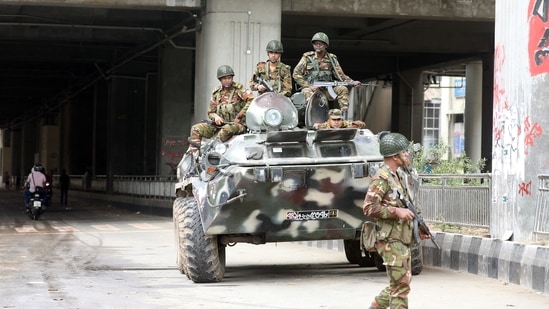 Bangladeshi Army soldiers patrol on the street after the government imposed a new curfew, in Dhaka. (PTI)