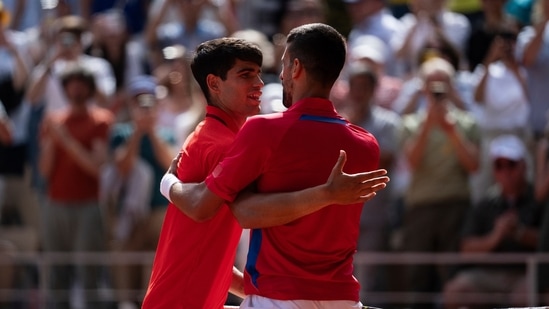 Serbia's Novak Djokovic and Spain's Carlos Alcaraz great each other after the men's singles tennis final at the Roland Garros(AP)