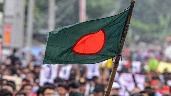 Protesters wave the Bangladesh national flag during a march in Dhaka amid the ongoing civil unrest. (AFP Photo)