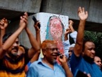 A mural of Prime Minister Sheikh Hasina is seen vandalised by protesters as people celebrate her resignation in Dhaka, Bangladesh. 