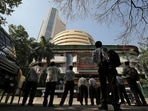 People look at a screen displaying the Sensex results on the facade of the Bombay Stock Exchange (BSE) building in Mumbai. (Reuters)