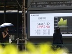 An electronic stock board displays the Nikkei 225 Stock Average outside a securities firm in Tokyo, Japan.(Bloomberg) An electronic stock board displays the Nikkei 225 Stock Average outside a securities firm in Tokyo, Japan.(Bloomberg)