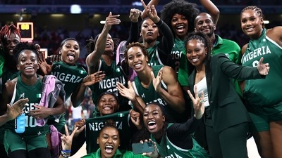 Nigeria's players and Nigeria's US coach Rena Wakama (Front 2ndR) pose as they celebrate after winning the women's preliminary round group B basketball match between Canada and Nigeria during the Paris 2024 Olympic Games at the Pierre-Mauroy stadium in Villeneuve-d'Ascq, northern France, on August 4, 2024. (Photo by Sameer AL-DOUMY / AFP) (AFP)