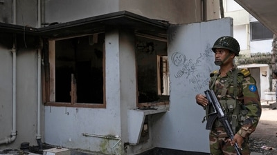 A soldier stands guard at the vandalised museum of Sheikh Mujibur Rahman, father of Sheikh Hasina who resigned as Prime Minister on Monday, in Dhaka, Bangladesh, (AP) A soldier stands guard at the vandalised museum of Sheikh Mujibur Rahman, father of Sheikh Hasina who resigned as Prime Minister on Monday, in Dhaka, Bangladesh, (AP)