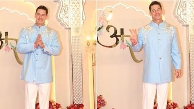 John Cena strikes a pose at the Ambani wedding in a light blue bandhagala kurta and white pants. He styled the look with tan brown dress shoes. (HT Photo/Varinder Chawla) John Cena strikes a pose at the Ambani wedding in a light blue bandhagala kurta and white pants. He styled the look with tan brown dress shoes. (HT Photo/Varinder Chawla)