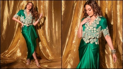 Sonakshi Sinha's ethnic green look redefines traditional fashion with a modern twist. Her green ensemble exudes sartorial flair, featuring a V-neck cropped top adorned with golden circular embellishments. Paired with a matching satin wrap skirt, she radiated modern glamour. (Instagram/@aslisona) Sonakshi Sinha's ethnic green look redefines traditional fashion with a modern twist. Her green ensemble exudes sartorial flair, featuring a V-neck cropped top adorned with golden circular embellishments. Paired with a matching satin wrap skirt, she radiated modern glamour. (Instagram/@aslisona)