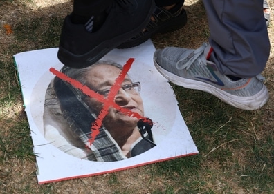 People stepped on an image of Sheikh Hasina after her resignation as PM in 2024. (Reuters)
