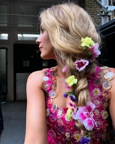 To elevate the look, Lively opted for a loose braid with purple, yellow, and pink flowers To elevate the look, Lively opted for a loose braid with purple, yellow, and pink flowers