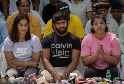 Indian wrestlers Vinesh Phogat, Bajrang Punia, and Sakshi Malik address a news conference as they take part in a sit-in protest (REUTERS)