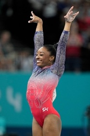 Simone Biles in a sparkly leotard. Simone Biles in a sparkly leotard.