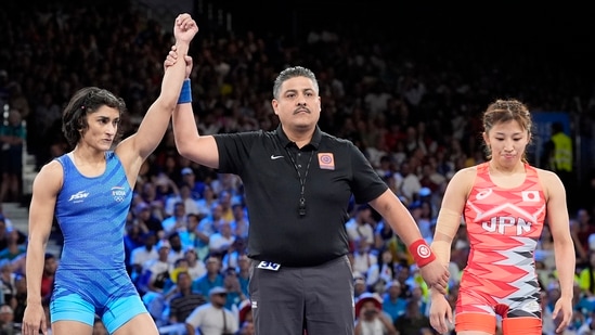 India's Vinesh Phogat, left, celebrates after defeating Japan's Yui Susaki in the round of 16 of the women's freestyle 50kg wrestling match