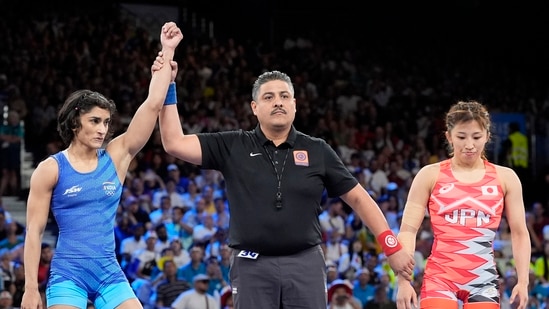 India's Vinesh Phogat, left, celebrates after defeating Japan's Yui Susaki in the round of 16 of the women's freestyle 50kg wrestling match