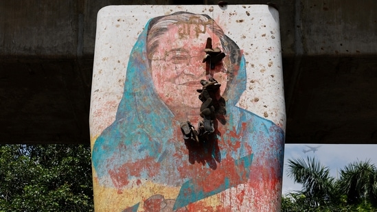 A view shows a mural of Bangladeshi Prime Minister Sheikh Hasina vandalised by protesters, a day after her resignation, in Dhaka, Bangladesh.(Reuters)