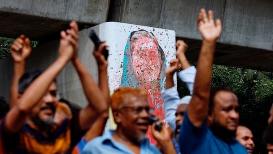 A mural of Prime Minister Sheikh Hasina is seen vandalised by protesters as people celebrate her resignation in Dhaka, Bangladesh. (Reuters)