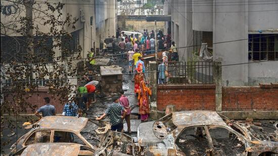 Damaged vehicles following a protest in Dhaka, Bangladesh, on Tuesday. (Bloomberg)