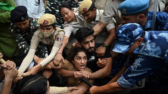 (FILES) Indian wrestlers Vinesh Phogat (C) with others are detained by the police 