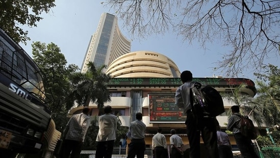 People look at a screen displaying the Sensex results on the facade of the Bombay Stock Exchange (BSE) building in Mumbai. (Reuters)