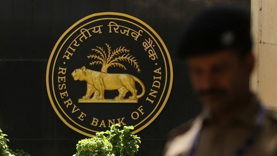 RBI MPC: A police officer walks past the Reserve Bank of India (RBI) logo inside its headquarters in Mumbai, India.(Reuters)