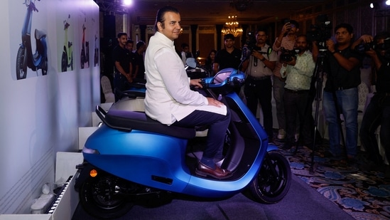 Bhavish Aggarwal, CEO of Ola Cabs, and founder of Ola Electric, sits on an Ola electric scooter after the press conference before the company's IPO launch in Mumbai. (Reuters)